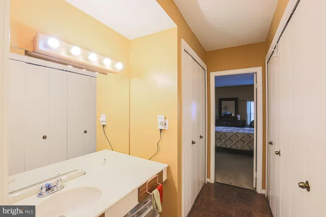 a bathroom with a granite countertop sink and a mirror