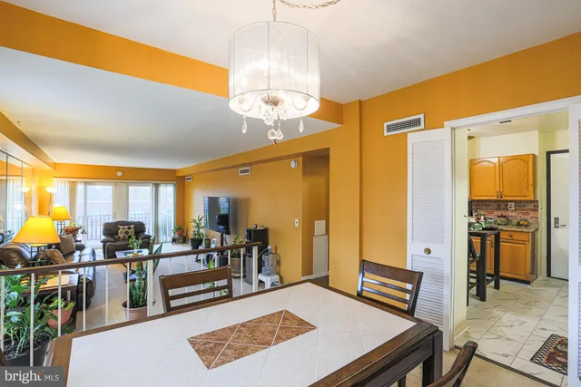 a view of a dining room with furniture wooden floor and chandelier