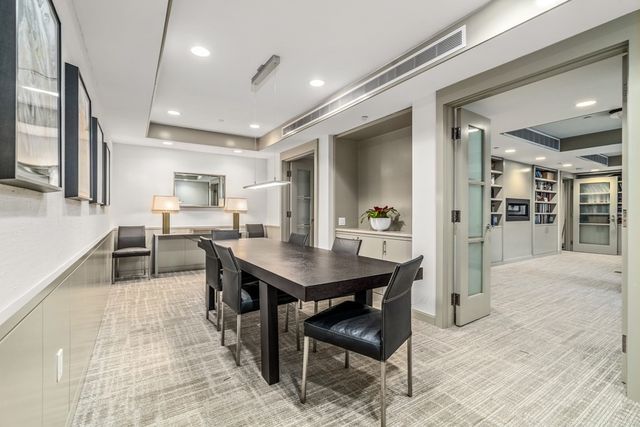 a room with gym equipment and kitchen view