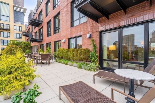 a view of a patio with couches and potted plants