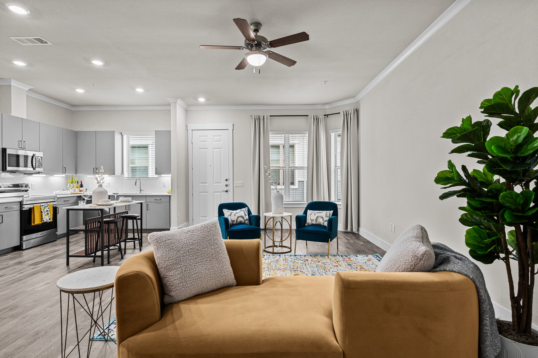 865 Limmer Loop, Unit 1014 Hutto, TX 78634 - Photo 11 of 37 a living room with furniture kitchen view and a potted plant