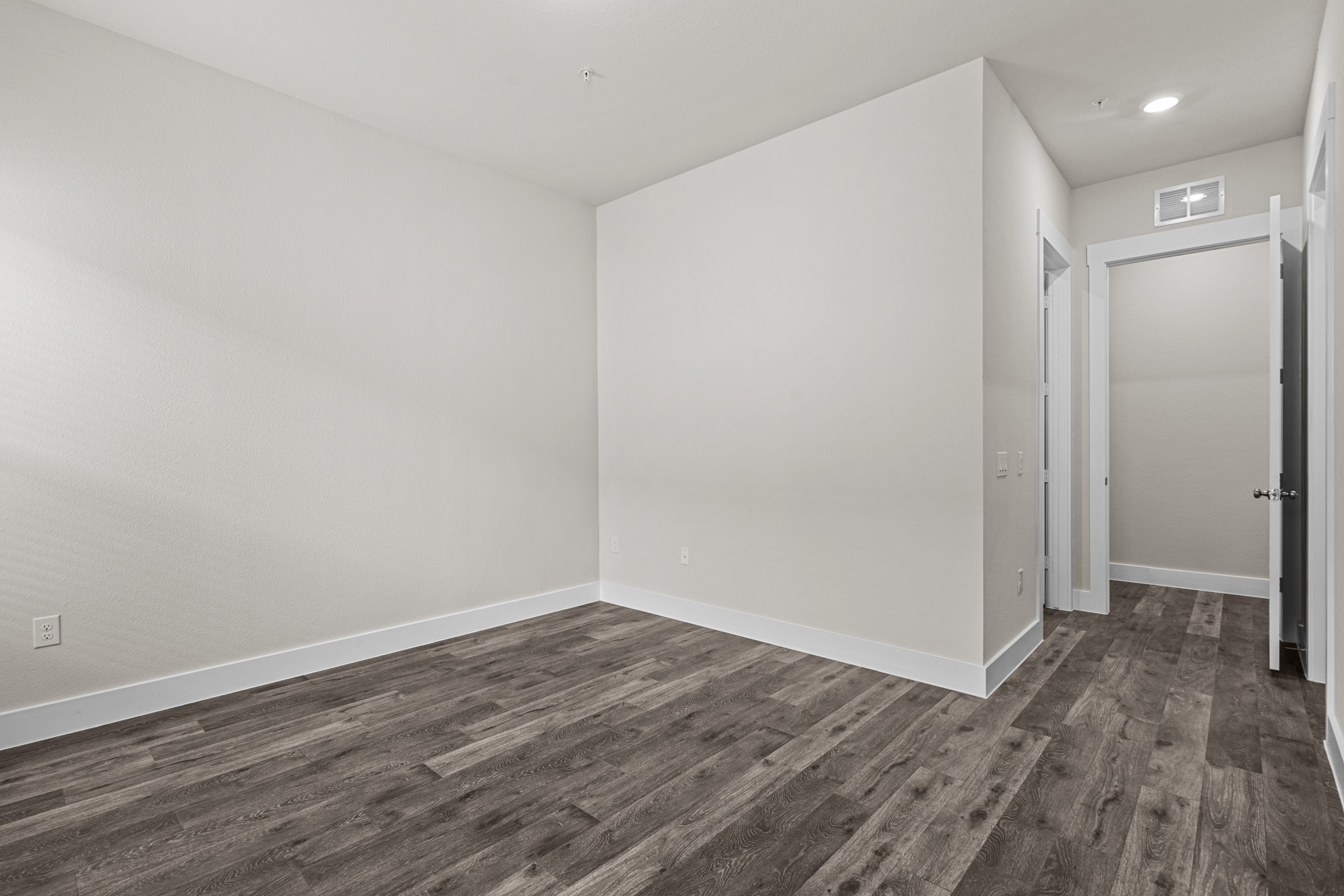 865 Limmer Loop, Unit 1014 Hutto, TX 78634 - Photo 13 of 37 a view of an empty room with wooden floor and closet