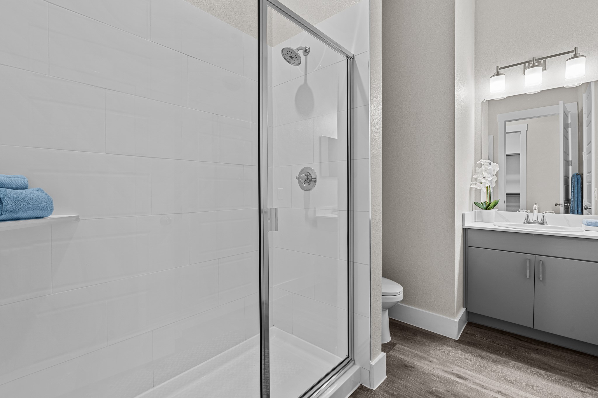 865 Limmer Loop, Unit 1014 Hutto, TX 78634 - Photo 17 of 37 a bathroom with a granite countertop sink toilet and shower