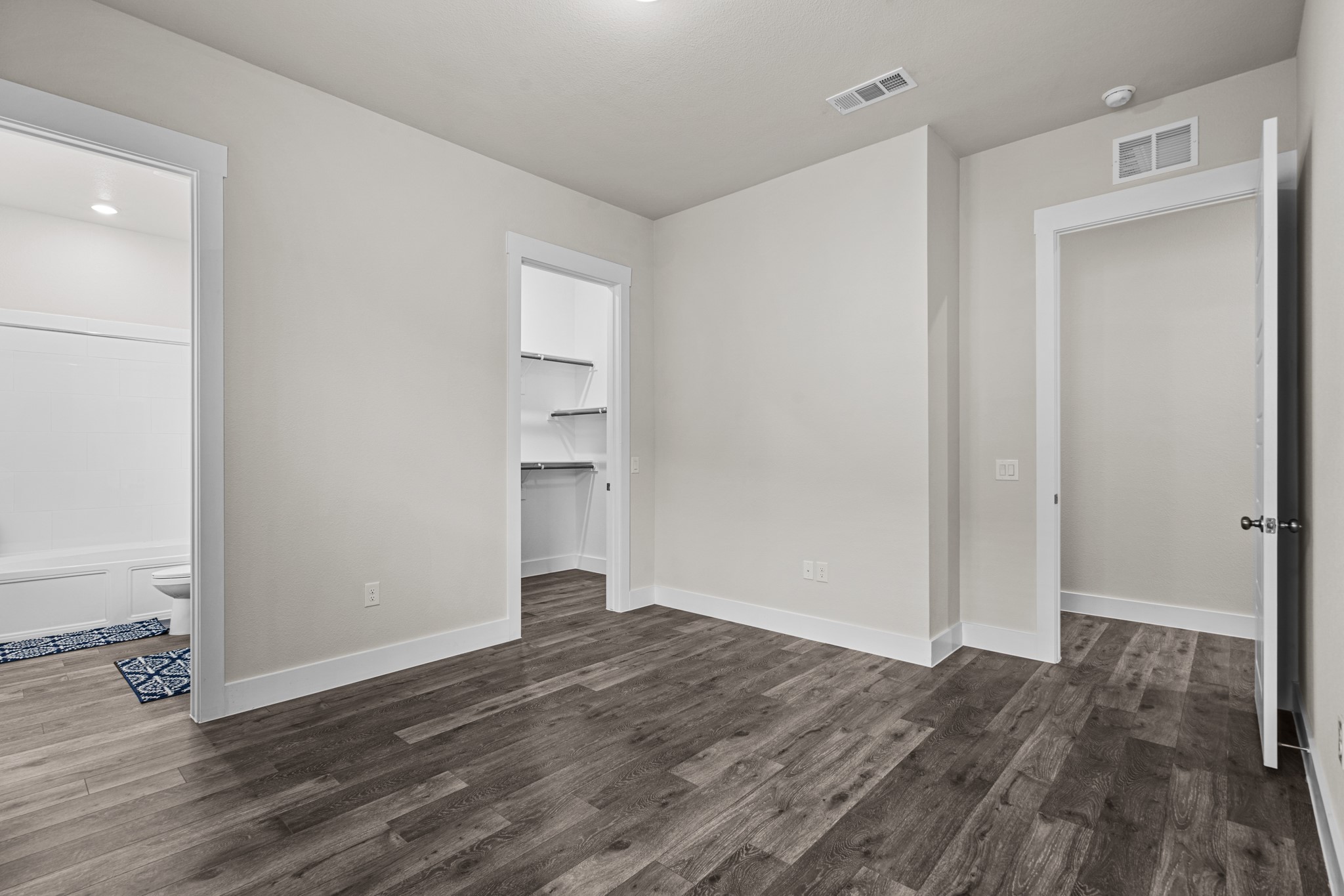 865 Limmer Loop, Unit 1014 Hutto, TX 78634 - Photo 19 of 37 a view of an empty room with wooden floor and closet