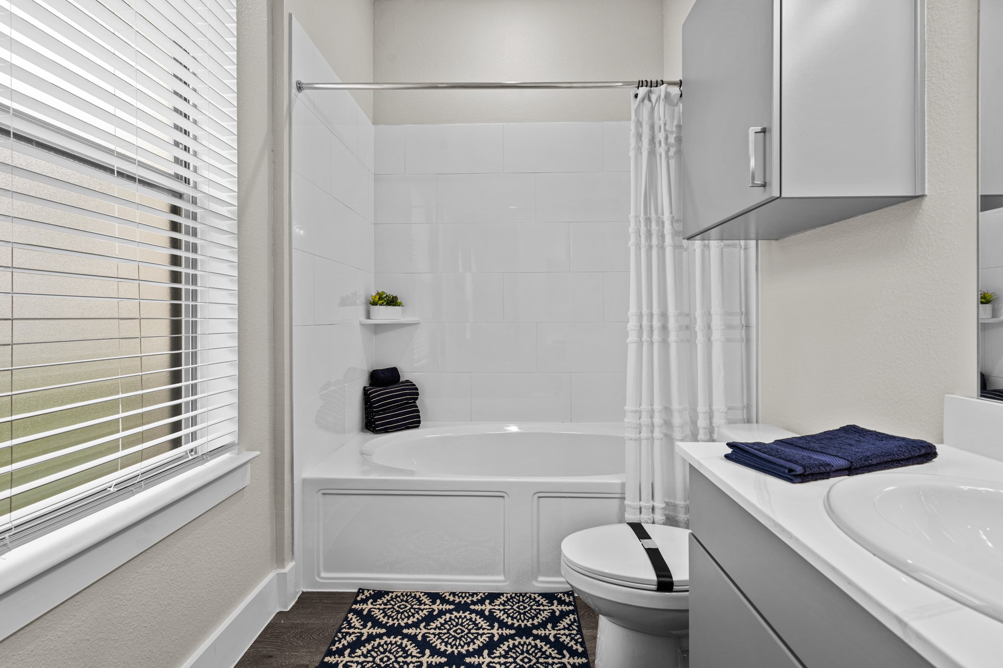 865 Limmer Loop, Unit 1014 Hutto, TX 78634 - Photo 24 of 37 a bathroom with a sink a toilet and shower