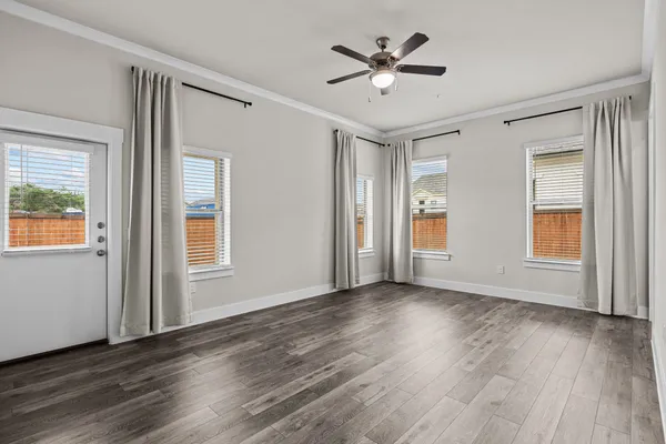wooden floor in an empty room with a window