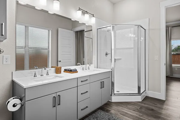 a bathroom with a double vanity sink mirror and double
