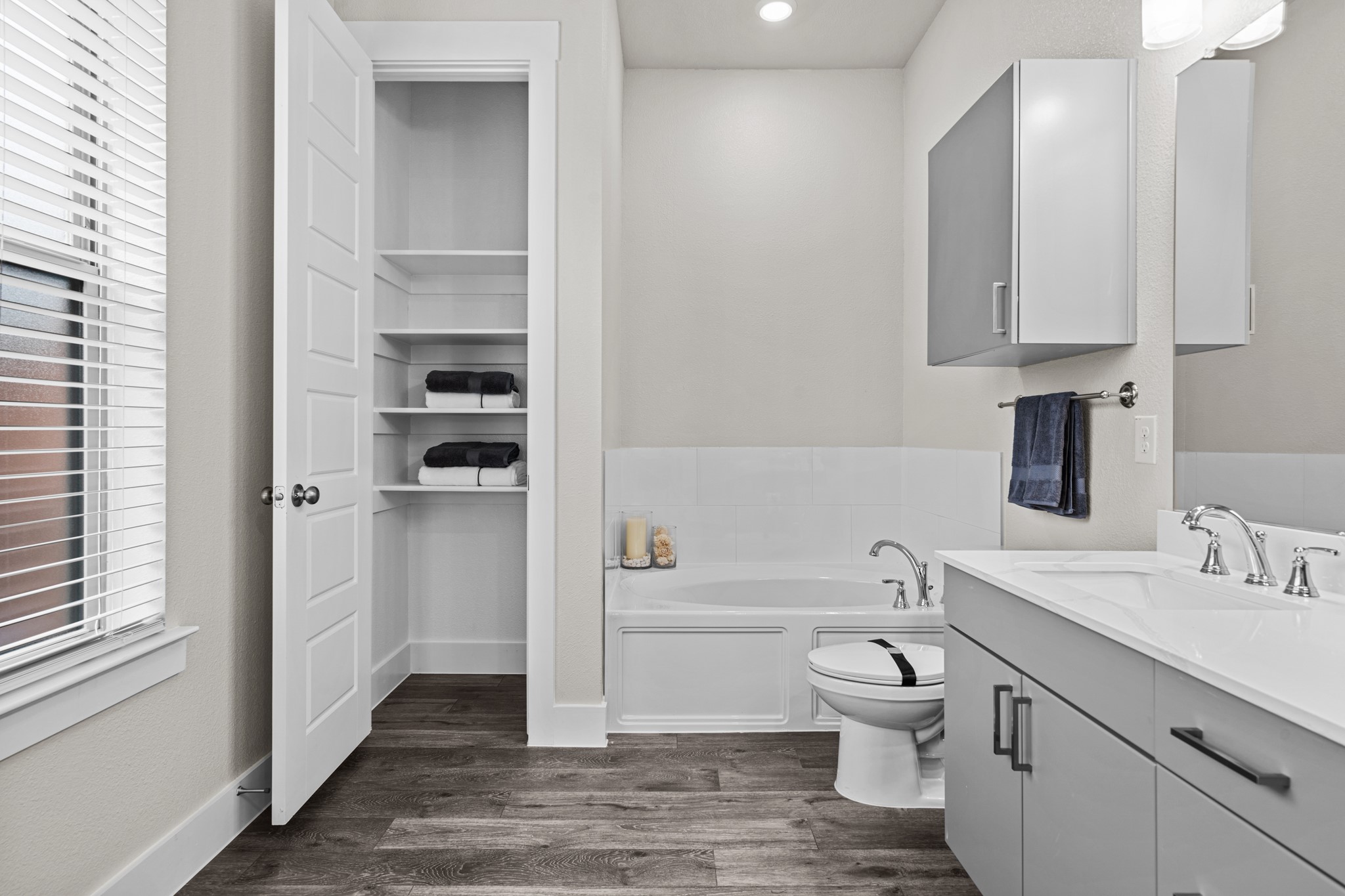 865 Limmer Loop, Unit 1014 Hutto, TX 78634 - Photo 33 of 37 a bathroom with a toilet a sink and a bathtub