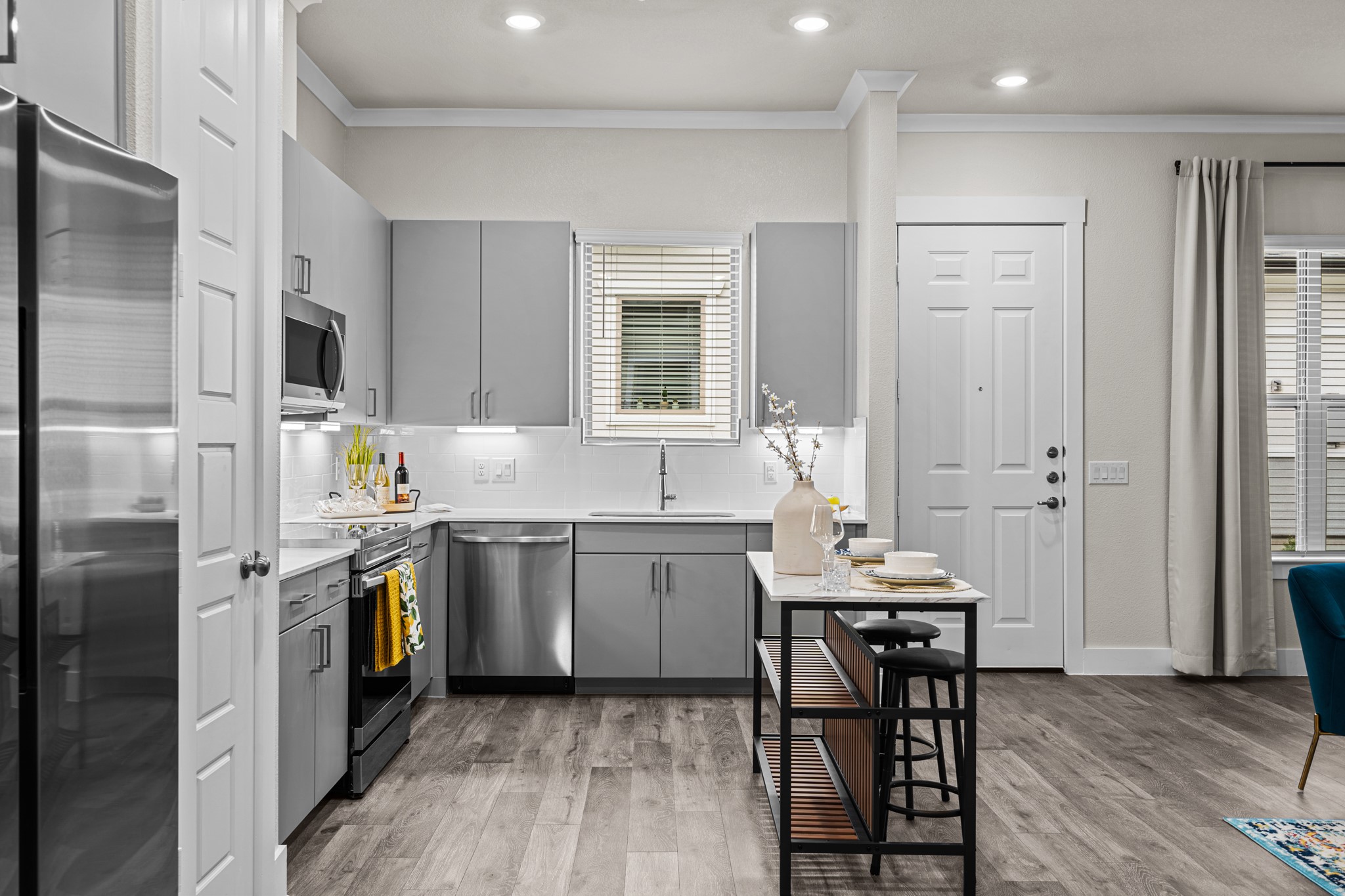 865 Limmer Loop, Unit 1014 Hutto, TX 78634 - Photo 5 of 37 a kitchen with a sink stove and refrigerator