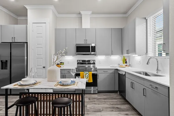 a kitchen with a stove a sink and a refrigerator