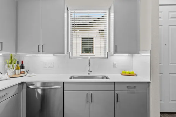 a kitchen with a sink cabinets and window