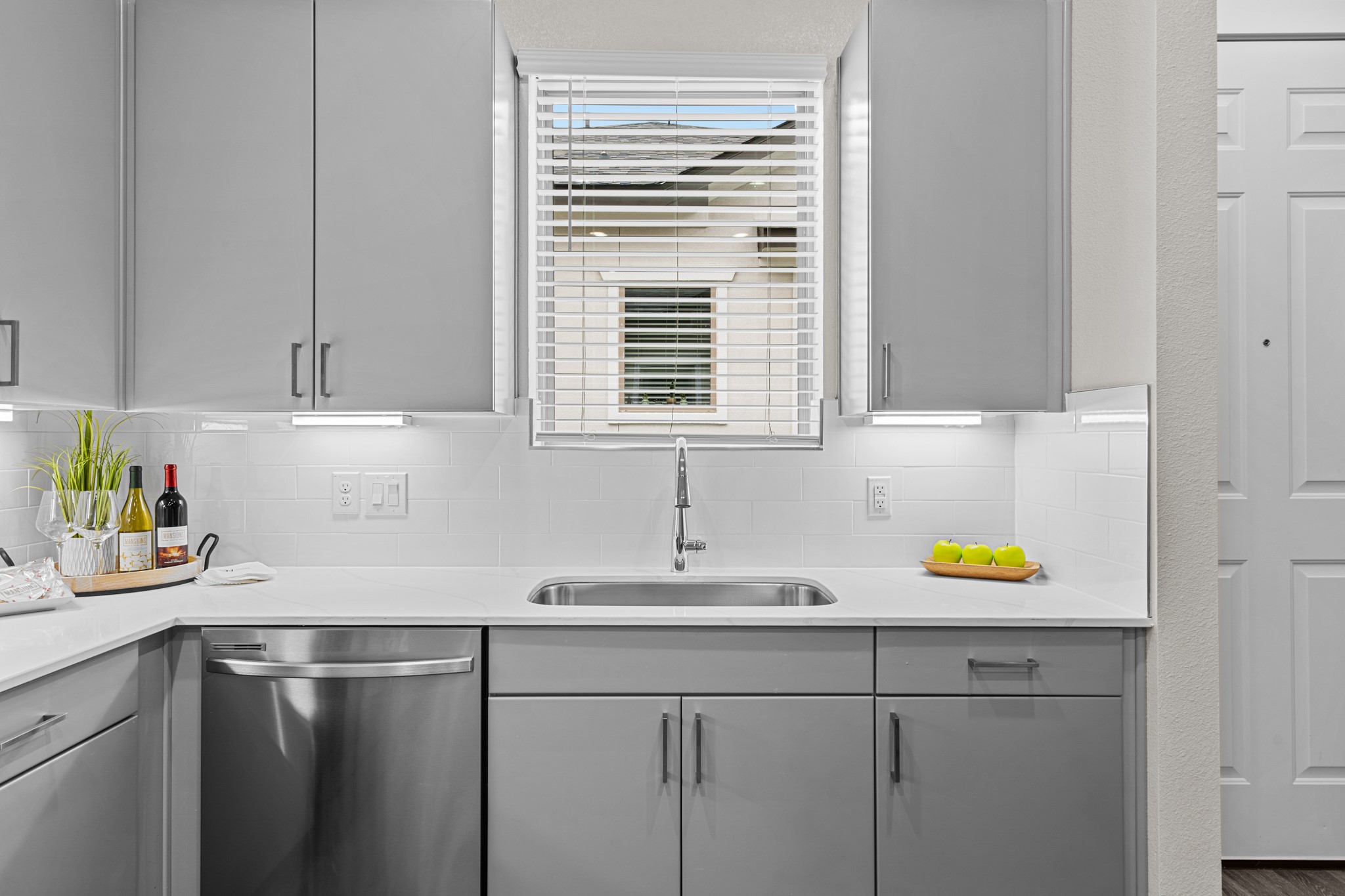 865 Limmer Loop, Unit 1014 Hutto, TX 78634 - Photo 10 of 37 a kitchen with a sink cabinets and window