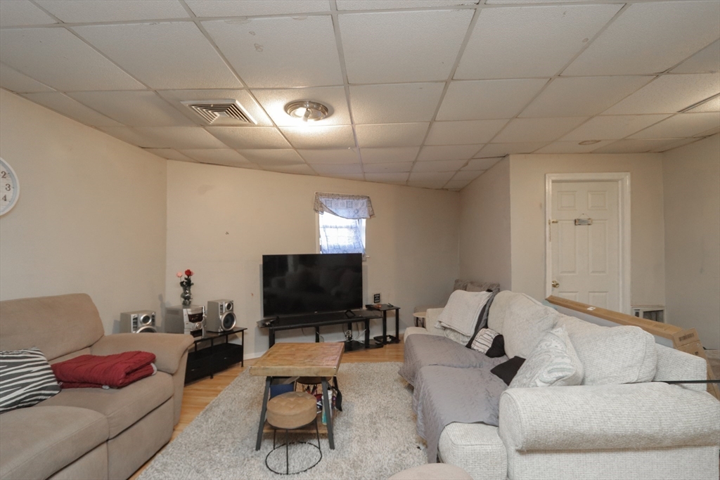 205 Elm Street Westfield, MA 01085 - Photo 11 of 24 a living room with furniture and a flat screen tv