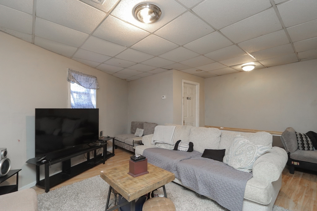 205 Elm Street Westfield, MA 01085 - Photo 12 of 24 a living room with furniture and a flat screen tv