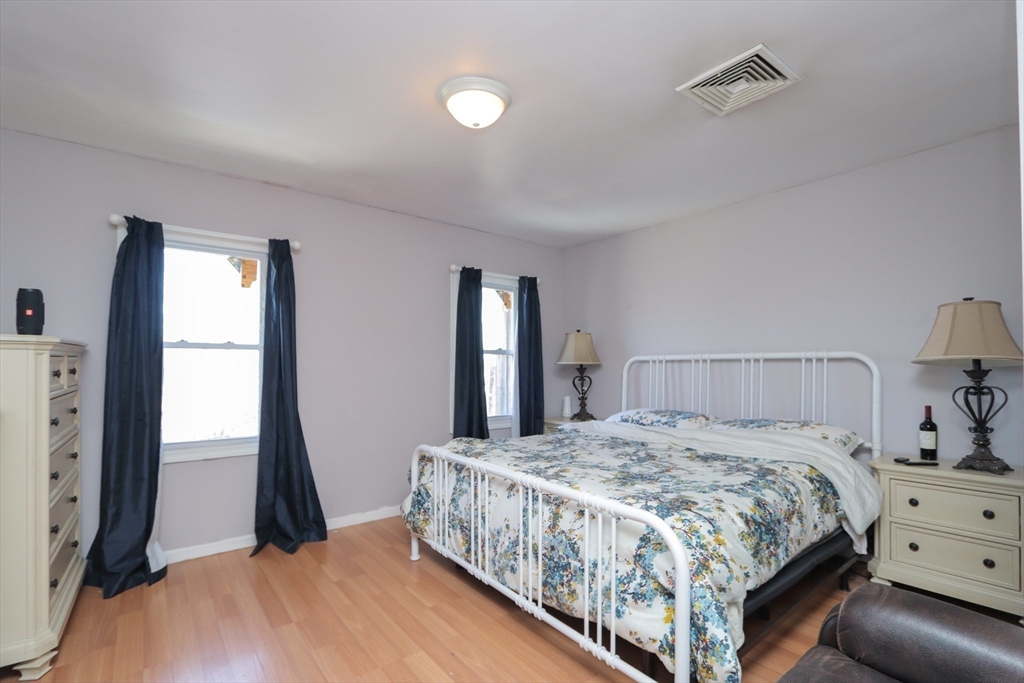 205 Elm Street Westfield, MA 01085 - Photo 19 of 24 a bedroom with a bed and large windows