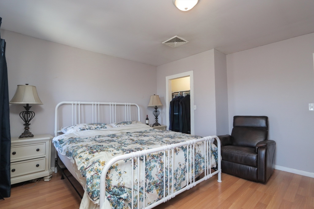205 Elm Street Westfield, MA 01085 - Photo 20 of 24 a bedroom with a bed and wooden floor