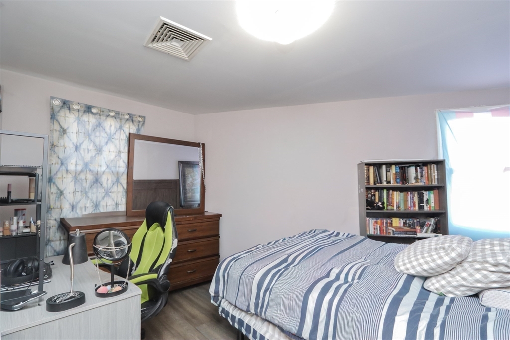 205 Elm Street Westfield, MA 01085 - Photo 23 of 24 a bedroom with bed and a book shelf