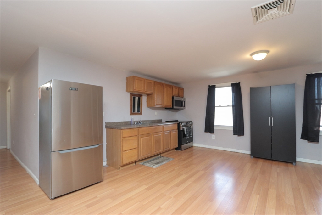 205 Elm Street Westfield, MA 01085 - Photo 6 of 24 a kitchen with stainless steel appliances a refrigerator and a stove top oven