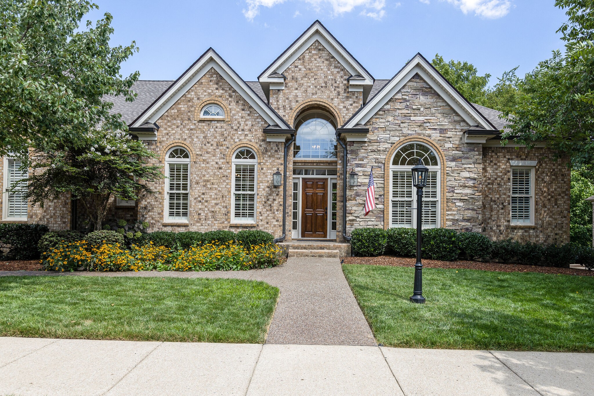1327 Cottingham Drive Franklin, TN 37067 - Photo 2 of 70 a front view of a house with a garden and plants