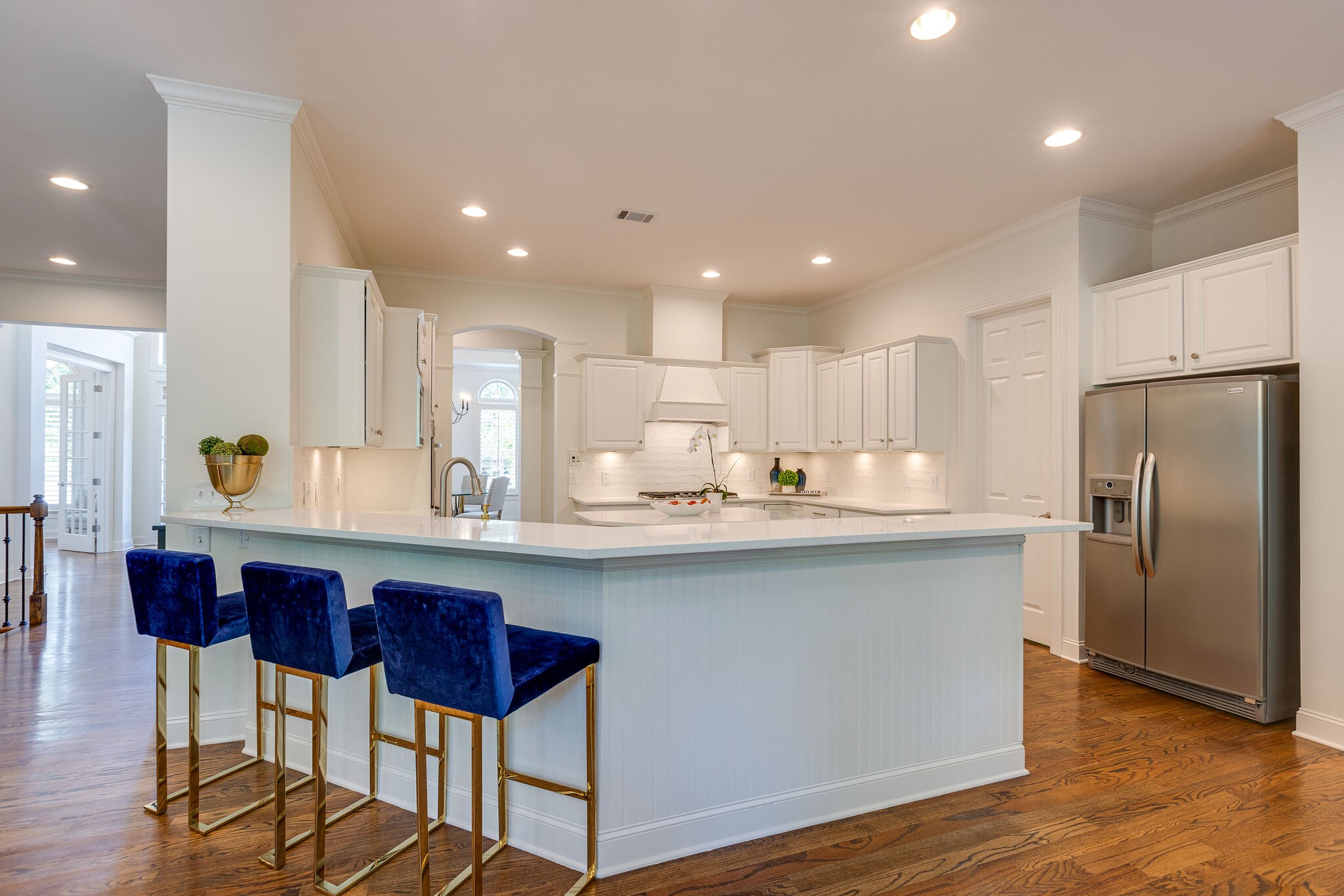 1327 Cottingham Drive Franklin, TN 37067 - Photo 21 of 70 a kitchen with stainless steel appliances granite countertop a sink a stove a refrigerator and island with wooden floor