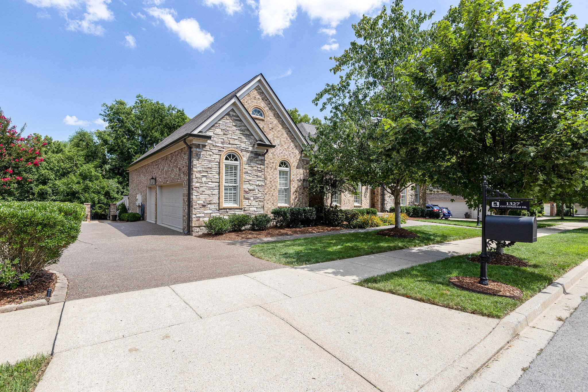 1327 Cottingham Drive Franklin, TN 37067 - Photo 3 of 70 a front view of a house with a yard and trees