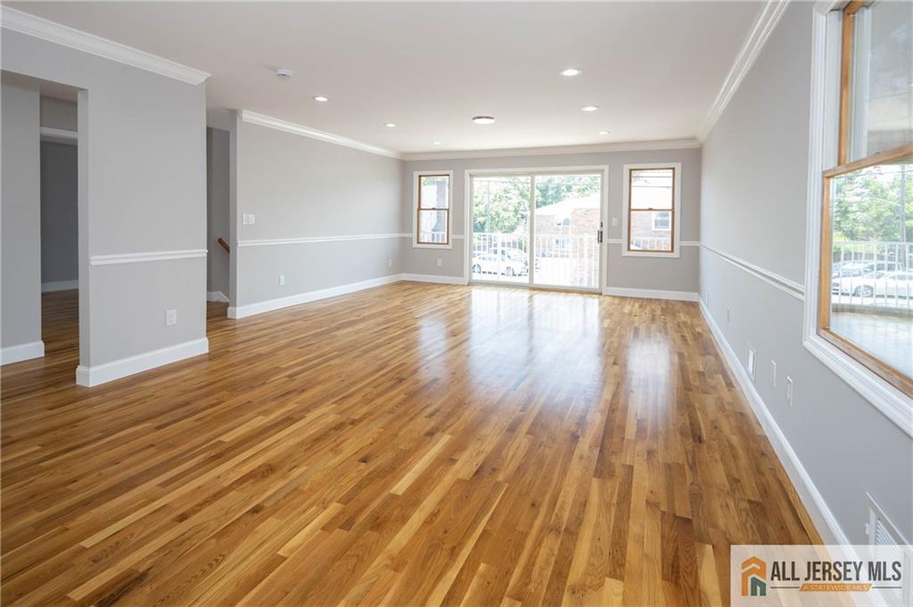 278 Rector Street Perth Amboy, NJ 08861 - Photo 13 of 47 an empty room with wooden floor and windows