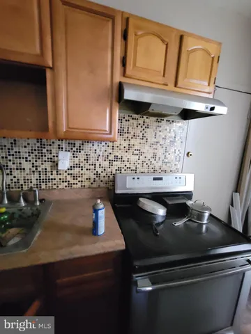 a view of a hallway and a livingroom with furniture