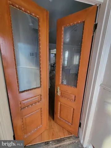 a view of a hallway with wooden floor and stairs