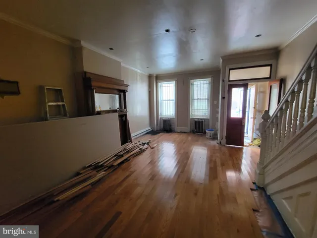 a dining room with furniture a chandelier and wooden floor