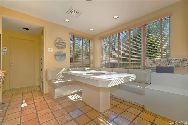 a spacious bathroom with a granite countertop sink a mirror and a bathtub