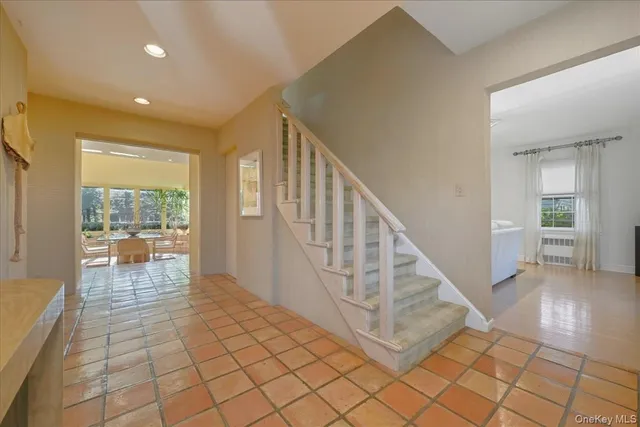 a view of staircase with furniture and a table
