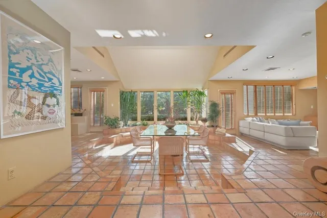 a living room with fireplace furniture and a large window