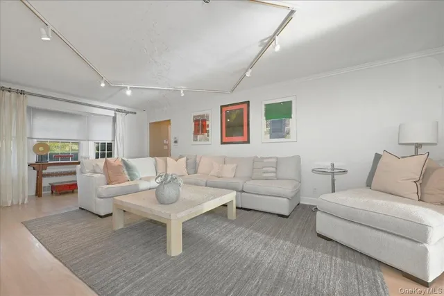 a living room with furniture a rug and a table