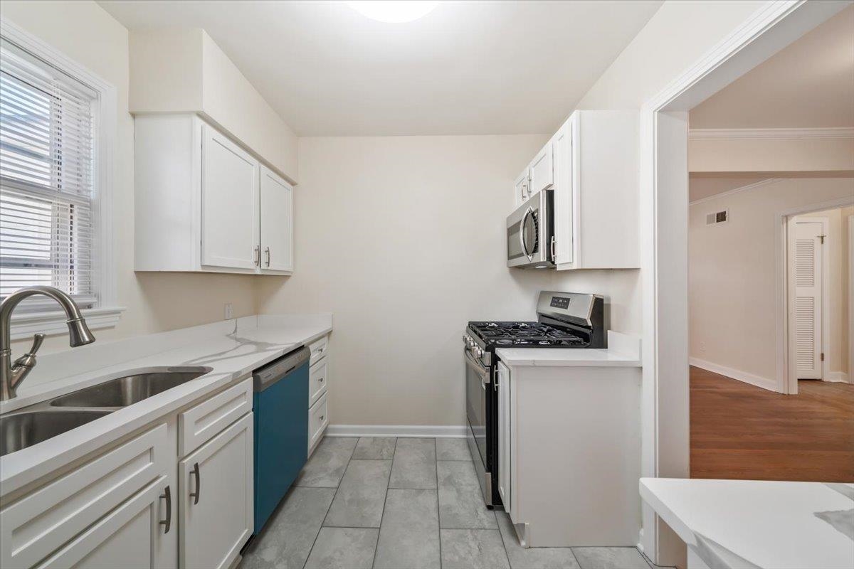 753 Ivy Road Memphis, TN 38117 - Photo 14 of 25 a kitchen with stainless steel appliances granite countertop a sink stove and refrigerator
