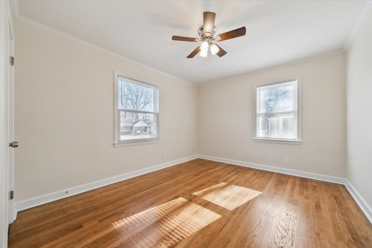 753 Ivy Road Memphis, TN 38117 - Photo 18 of 25 a view of an empty room with wooden floor and a window