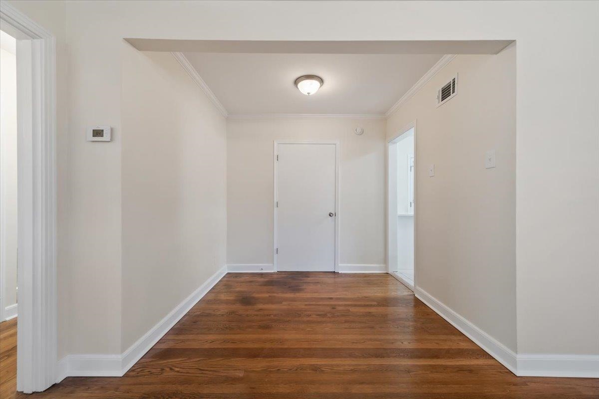 753 Ivy Road Memphis, TN 38117 - Photo 4 of 25 Hallway with dark wood-style floors and ornamental molding