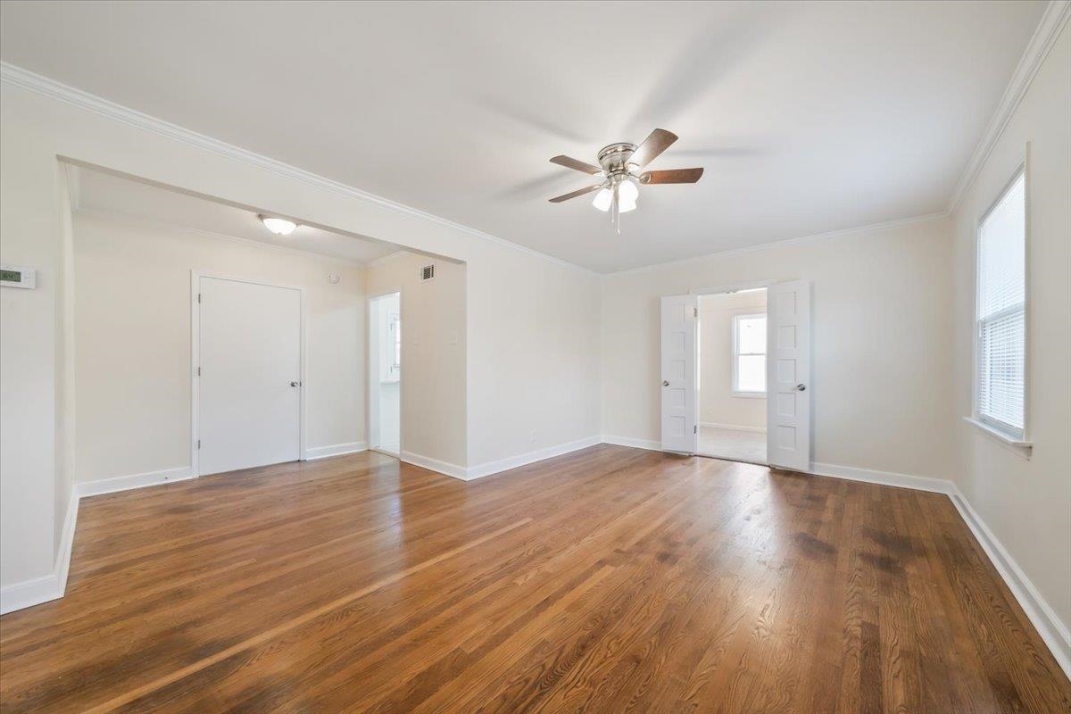 753 Ivy Road Memphis, TN 38117 - Photo 5 of 25 a view of empty room with wooden floor and ceiling fan