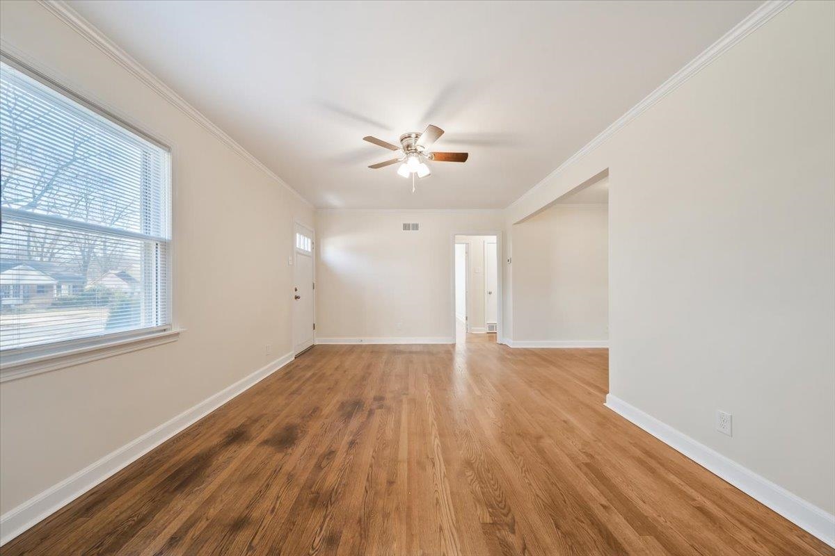 753 Ivy Road Memphis, TN 38117 - Photo 8 of 25 an empty room with wooden floor and windows