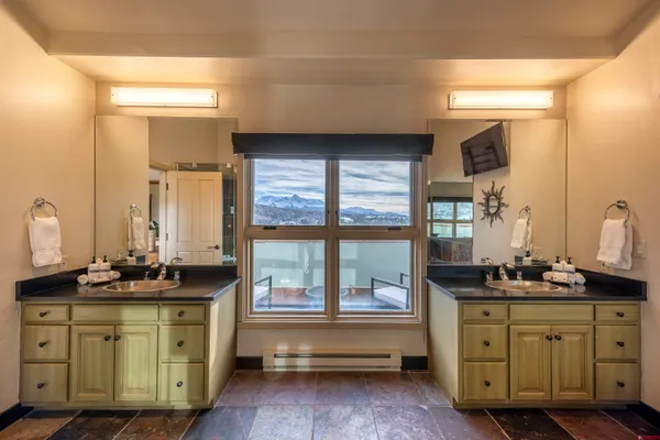 a bathroom with a granite countertop sink toilet a mirror and shower
