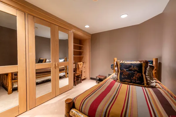 a dining room with furniture and a floor to ceiling window
