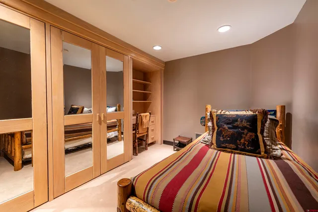 a bedroom with two beds and a flat screen tv