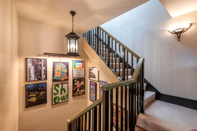 a bathroom with a granite countertop toilet sink and mirror