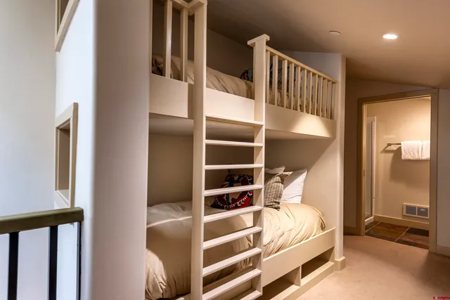 a dining room with furniture and a floor to ceiling window