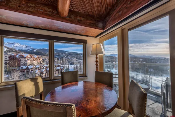 a kitchen with a table chairs sink and cabinets