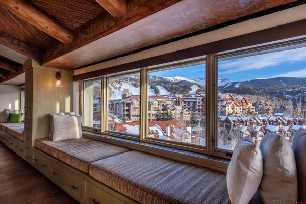 a kitchen with stainless steel appliances granite countertop a refrigerator a stove and a sink with wooden floors