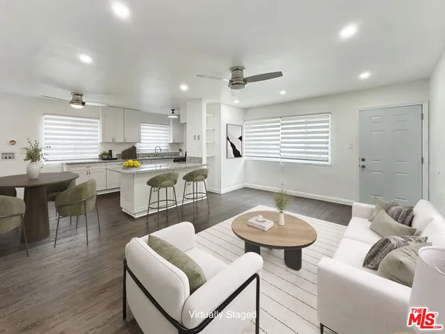 a kitchen with a dining table chairs stove and kitchen view