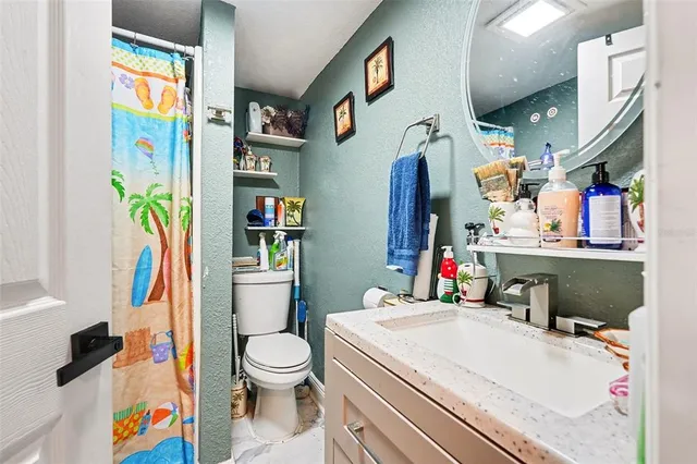 a bedroom with bed and a chandelier