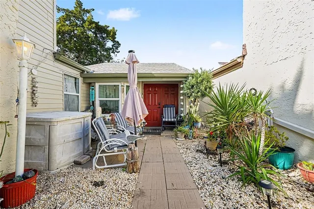 a house with potted plants in front of it