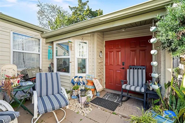a view of a porch with chairs and table in patio