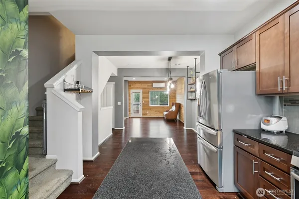 a kitchen with stainless steel appliances granite countertop a refrigerator and a stove